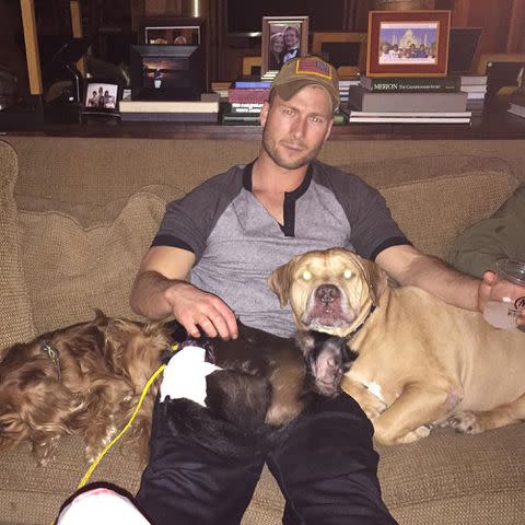 <p>Glen Powell Instagram</p> Glenn Powell sits with his family's pets