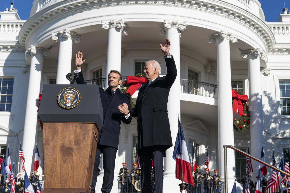 French President Emmanuel Macron, left, and President Joe Biden wave during a State Arrival Ceremony on the South Lawn of the White House in Washington, Thursday, Dec. 1, 2022. (AP Photo/Alex Brandon)