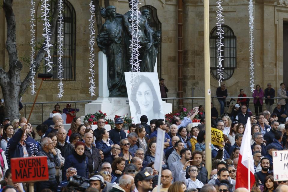 People stage a protest in La Valletta, Malta, Sunday, Dec. 1, 2019. Malta's embattled prime minister has received a pledge of confidence from Labor Party lawmakers amid demands for his resignation by citizens angry over alleged links of his former top aide to the car bomb killing of a Maltese anti-corruption journalist. Hours later, thousands of Maltese protested outside a courthouse demanding that Joseph Muscat step down. (AP Photo)