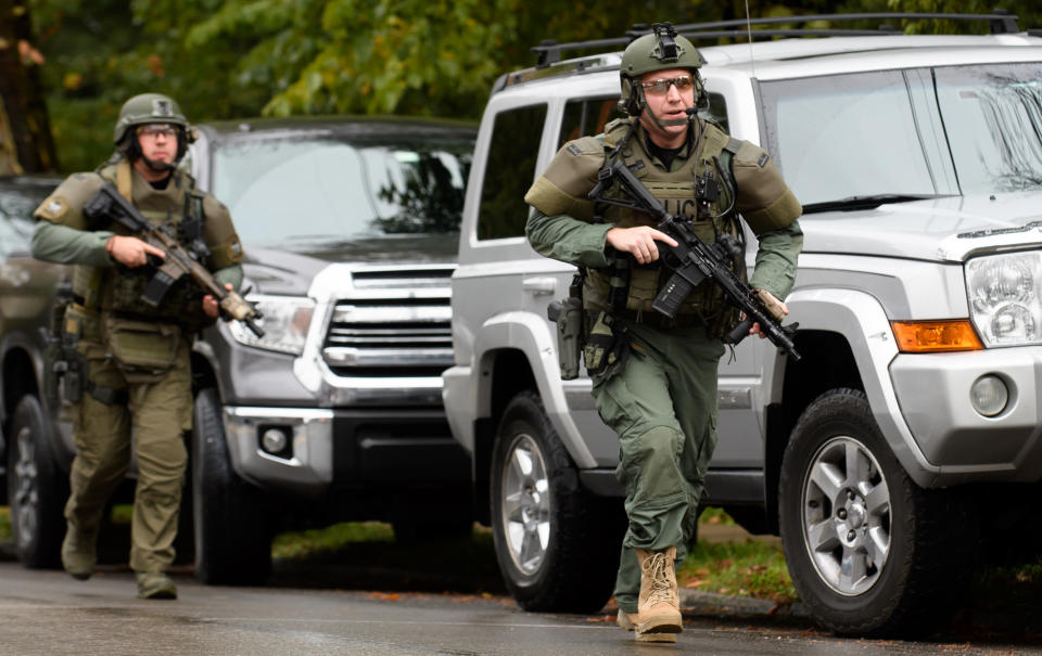 Armed officers rush to the scene where at lest 11 people were shot dead. Source: Getty