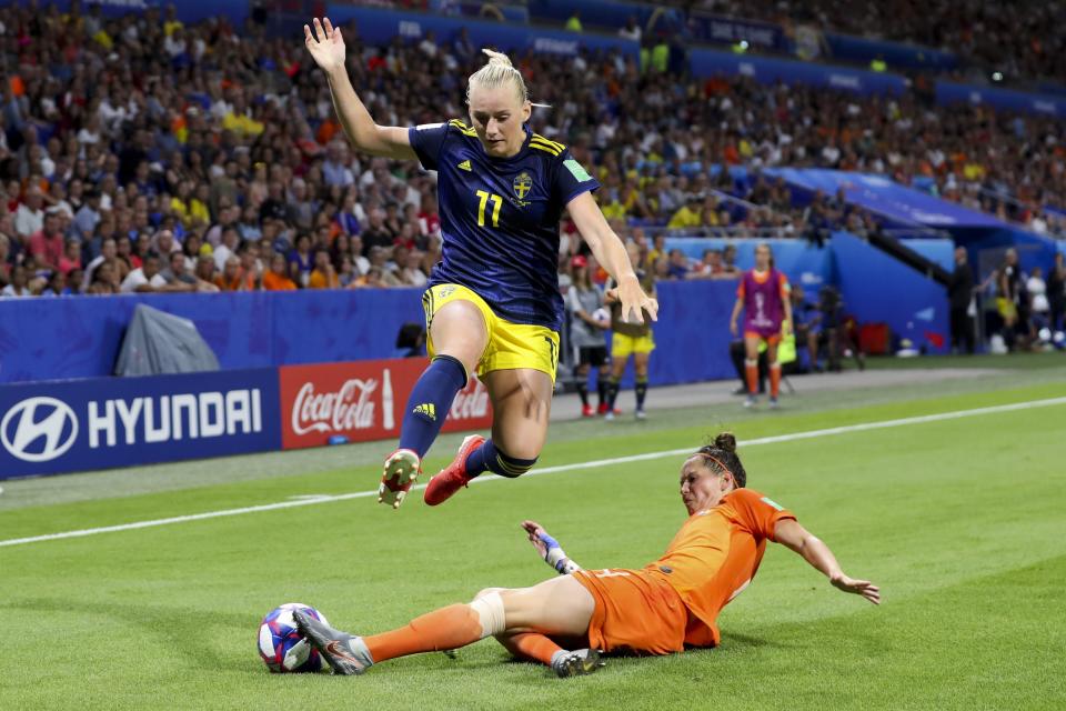 Sweden's Stina Blackstenius is tackled by Netherlands' Merel Van Dongen, bottom, during the Women's World Cup semifinal soccer match between the Netherlands and Sweden, at the Stade de Lyon outside Lyon, France, Wednesday, July 3, 2019. (AP Photo/Francisco Seco)