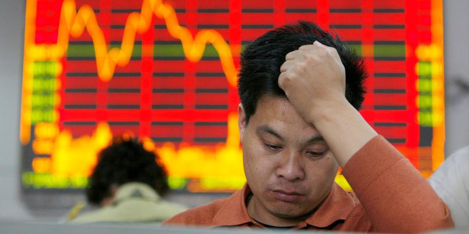 An investor checks his stocks value at a stock exchange market in Shanghai October 23, 2007.