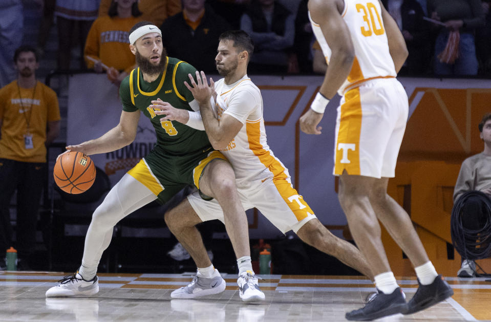 Norfolk State forward Tyrel Bladen (8) works for a shot as he's defended by Tennessee guard Santiago Vescovi during the first half of an NCAA college basketball game Tuesday, Jan. 2, 2024, in Knoxville, Tenn. (AP Photo/Wade Payne)