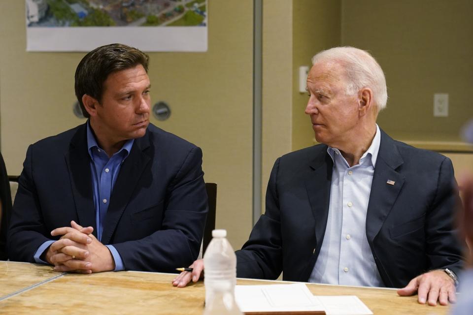 President Joe Biden, right, looks at Florida Gov. Ron DeSantis, left, during a briefing with first responders and local officials in Miami, Thursday, July 1, 2021, on the condo tower that collapsed in Surfside, Fla., last week.