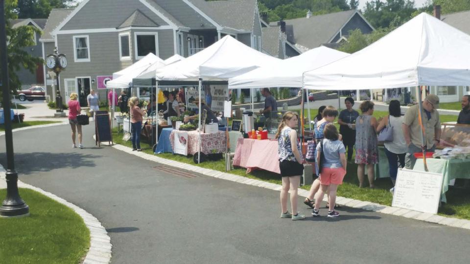 Visitors check out the Farmers Market at the Shoppes at Lafayette Sunday, June 2, 2019.