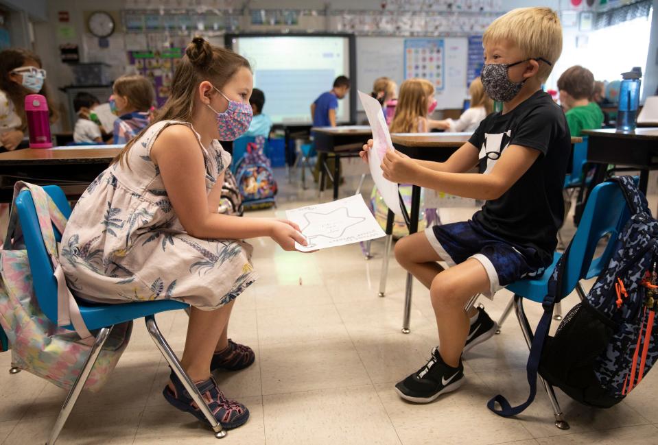 First-graders Ella Siciliano, left, and Crosley Roewer, show each other what they wish for during an assignment in Julie Fischer's class at J.F. Burns Elementary, on Aug. 31, 2021. The curriculum is part of an evidence-based program called the Character Effect developed by Beech Acres Parenting Center. Beech Acres trains the teachers on how to weave the teachings into their day, little by little. The idea is to teach social-emotional intelligence and demonstrate positive character traits.