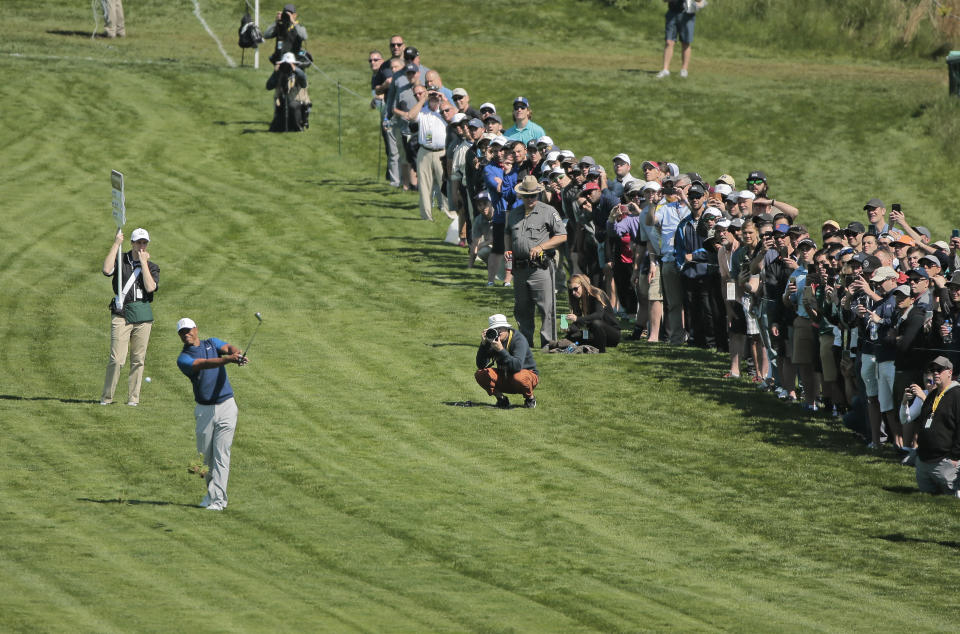 Tiger Woods hits out of the rough on the 16th hole during the first round of the PGA Championship golf tournament, Thursday, May 16, 2019, at Bethpage Black in Farmingdale, N.Y. (AP Photo/Andres Kudacki)