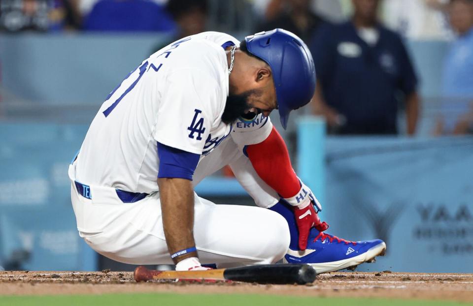 Teoscar Hernández grabs his foot in agony after getting hit by a pitch in the first inning Friday against the Guardians.