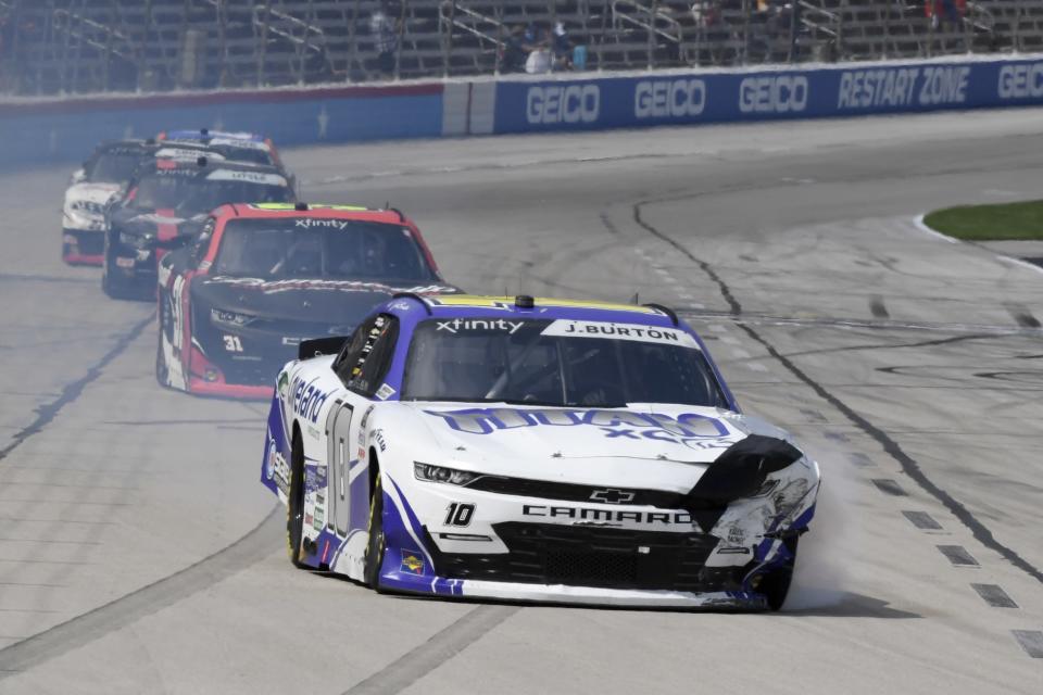 Jeb Burton, front, leaves a smoke trail after crashing during a NASCAR Xfinity Series auto race at Texas Motor Speedway in Fort Worth, Texas, Saturday, June 12, 2021. (AP Photo/Larry Papke)
