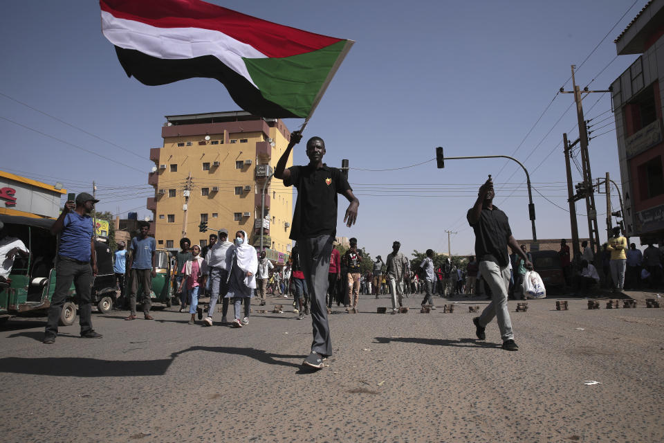 People march during a protest to denounce the October 2021 military coup, in Khartoum, Sudan, Sunday, Jan. 9, 2022. The United Nations said Saturday it would hold talks in Sudan to try to get the country's democratic transition back on track after it was derailed by the coup. (AP Photo/Marwan Ali)