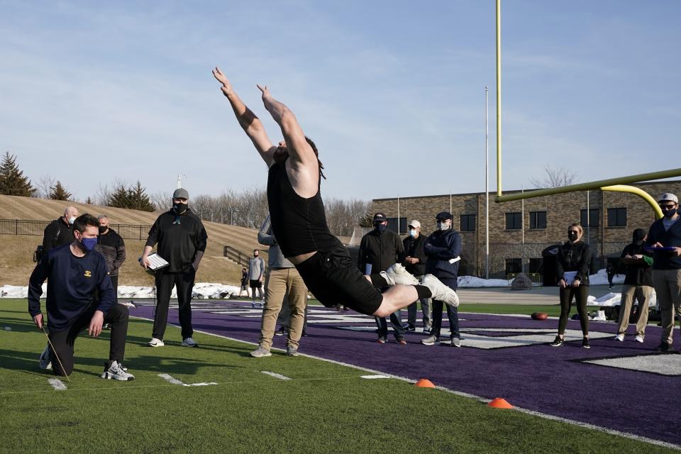 UW Whitewater lineman Quinn Meinerz jumps at the school's pro football day Tuesday, March 9, 2021, in Whitewater, Wisc. The only FCS teams hosting pro days this year were Central Arkansas, North Dakota State and South Dakota State. Division III Wisconsin-Whitewater held one only because its Senior Bowl revelation, offensive lineman Quinn Meinerz, warranted another look after his team did not play in the fall. (AP Photo/Morry Gash)