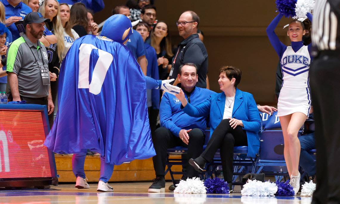 Mickie Krzyzewski greets the Blue Devil as her husband former head coach Mike Krzyzewski sits next to her during the second half of Duke’s 68-64 victory over Notre Dame at Cameron Indoor Stadium in Durham, N.C., Tuesday, Feb. 14, 2023.
