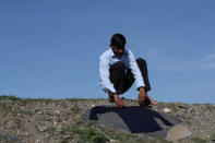 An Afghan migrant puts his washed shirt to dry near a bus terminal, as he struggles to find buses to take them to western Turkish cities, after crossing the Turkey-Iran border in Agri, eastern Turkey, April 11, 2018. Picture taken April 11, 2018. REUTERS/Umit Bektas