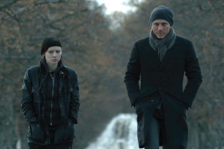 Rooney Mara and Daniel Craig walk together in The Girl with the Dragon Tattoo.