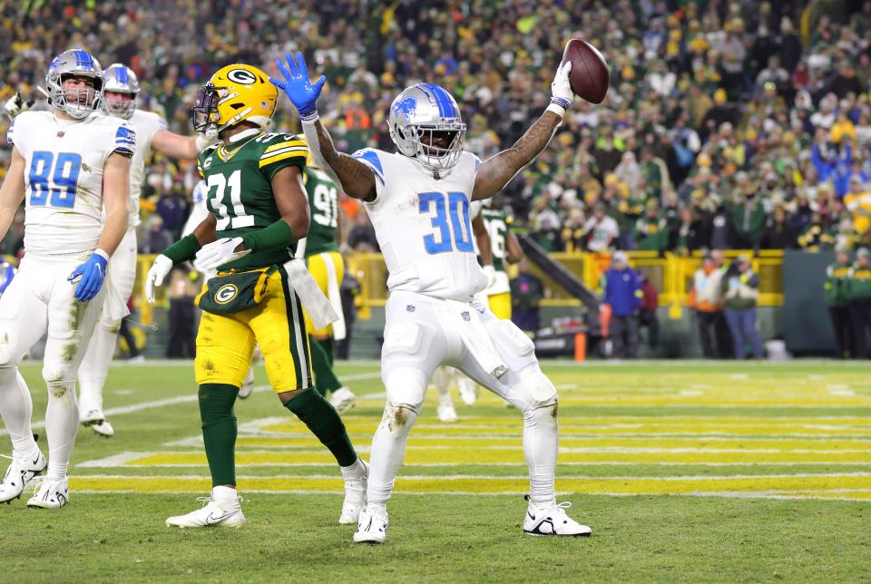 Jamaal Williams #30 of the Detroit Lions celebrates with teammates after a touchdown during the third quarter against the Green Bay Packers at Lambeau Field on January 08, 2023 in Green Bay, Wisconsin.