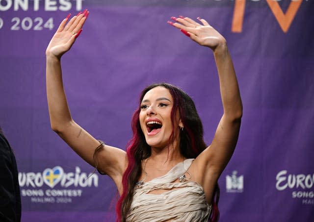 Eden Golan representing Israel waves during a press meeting with the entries that advanced to the final after the second semi-final of the Eurovision Song Contest 