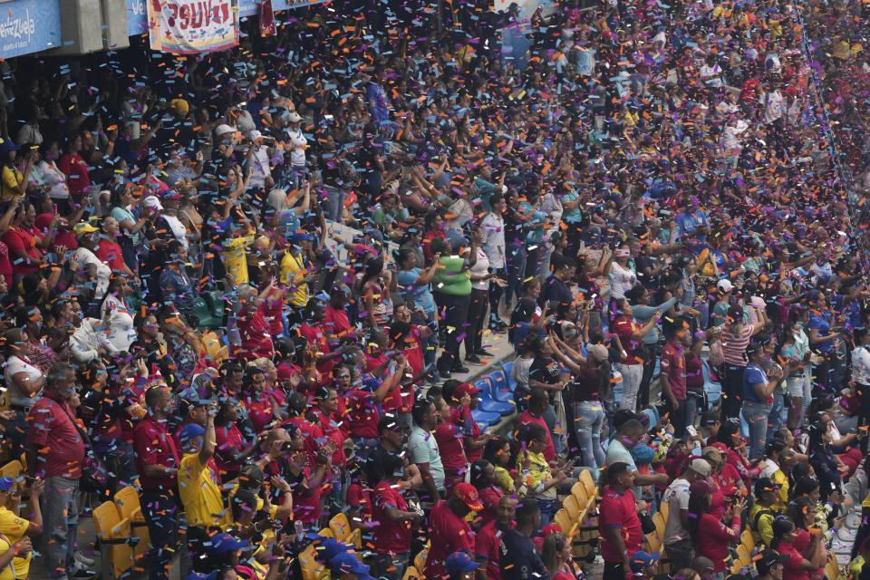Confetti rains over spectators at the Alba Games' opening ceremony inside the baseball stadium in La Guaira, Venezuela, Friday, April 21, 2023. (AP Photo/Ariana Cubillos)
