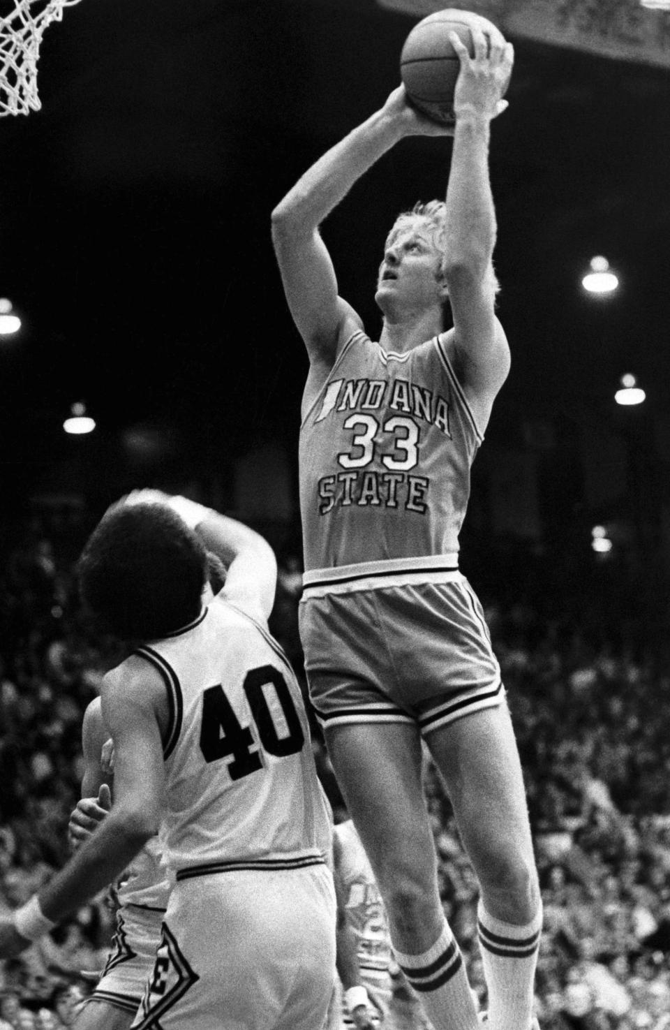 FILE - Indiana State University All-American Larry Bird (33) goes up for two points over the defense of University of Evansville's Barry Weston, during an NCAA college basketball game in Evansville, Ind., Dec. 2, 1978. Bird scored 40 points. Indiana State won 74-70. (AP Photo/File)