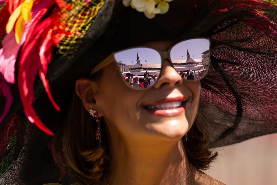 Cara Montgomery of Louisville looked up at the Twin Spires upon arriving at Churchill Downs on Thursday, May 4, 2023