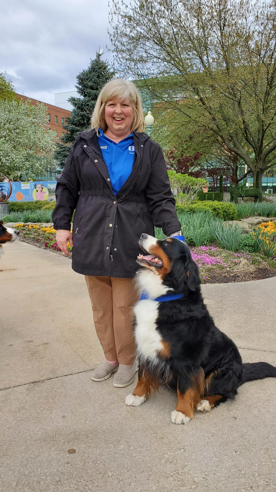 Jeannie Bussey poses outside of Akron Children's Hospital with her dog Faith.