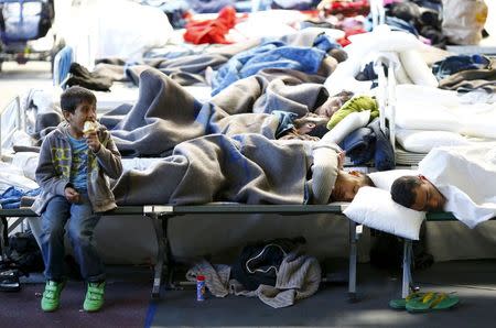 Migrants rest at a temporary shelter in a sports hall in Hanau, Germany, October 1, 2015. REUTERS/Kai Pfaffenbach