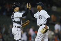 Detroit Tigers catcher Jake Rogers, left, and Jonathan Schoop celebrate after the final out in the ninth inning of a baseball game against the St. Louis Cardinals in Detroit, Tuesday, June 22, 2021. Detroit won 8-2. (AP Photo/Paul Sancya)