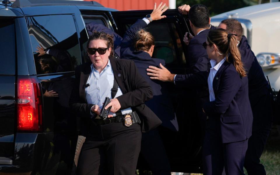 Secret service agents bundle Donald Trump into his bulletproof car