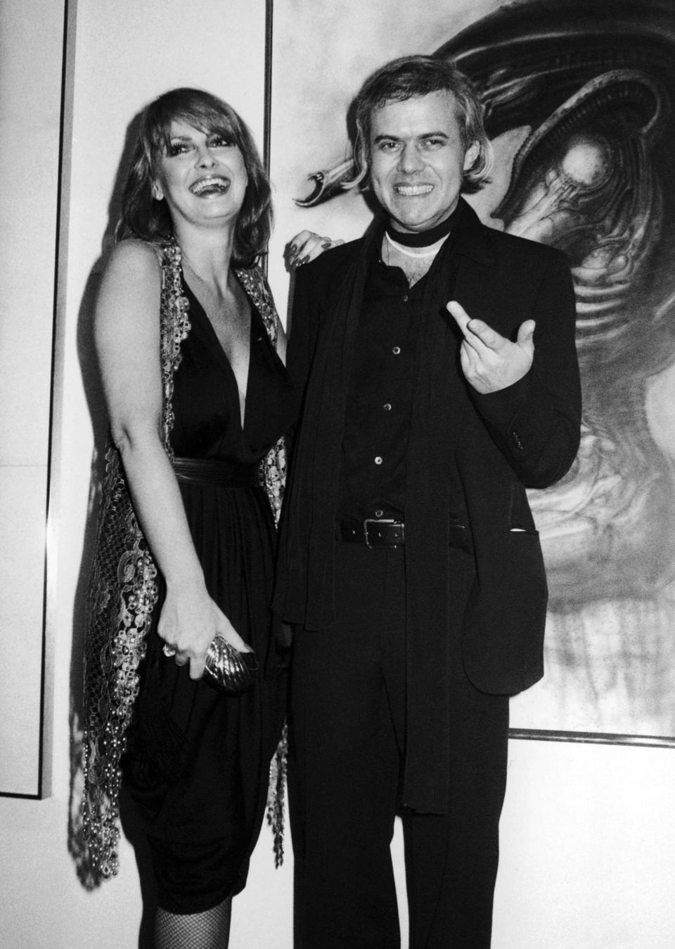 FILE - In this April 1980 file photo, Swiss Artist H.R. Giger, who was nominated for an academy award for his visual effects for the movie "Alien", right, poses with model Anneka Vasta at the opening of an exhibition in New York. Navy investigators are asking for public help as they probe the death of the former Penthouse model whose body washed up in San Diego County.  Vasta, was called Anneka Di Lorenzo as the 1975 Penthouse Pet of the Year.  (AP Photo/Bocklett,File)