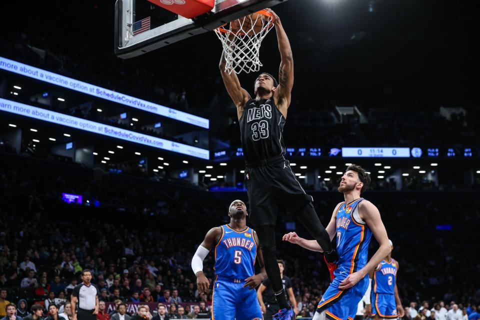 Jan 5, 2024; Brooklyn, New York, USA; Brooklyn Nets center Nic Claxton (33) drives past Oklahoma City Thunder forward Chet Holmgren (7) for a dunk in the first quarter at Barclays Center. Mandatory Credit: Wendell Cruz-USA TODAY Sports