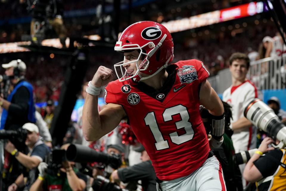 ATLANTA, GEORGIA - DECEMBER 31: Quarterback Stetson Bennett (13) of the Georgia Bulldogs reacts after a rushing touchdown against the Ohio State Buckeyes during the 2022 College Football Playoff Semifinal at the Chick-fil-A Peach Bowl on December 31, 2022, in Atlanta, Georgia. (Photo by Paul Abell/Chick-fil-A Peach Bowl)