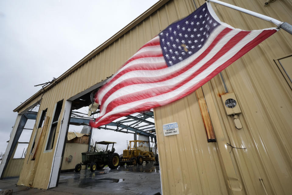 An American flag flies outside a damaged business in downtown Rolling Fork, Miss., on March, 22, 2024. The town of Rolling Fork has struggled to rebuild after a devastating tornado struck last year. Buildings throughout town remain boarded up, and the remnants of destroyed properties dot the landscape. The tornado killed 14 residents and reduced the town to rubble as it charted a merciless path across one of the country’s poorest regions. (AP Photo/Rogelio V. Solis)