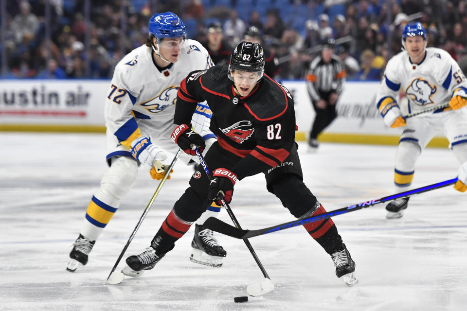 Carolina Hurricanes center Jesperi Kotkaniemi (82) controls the puck in front of Buffalo Sabres center Tage Thompson (72) during the first period of an NHL hockey game in Buffalo, N.Y., Wednesday, Feb. 1, 2023. (AP Photo/Adrian Kraus)