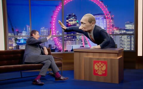 Former Labour press chief Alastair Campbell high fives the 3D digital cartoon of Putin - Credit: PA