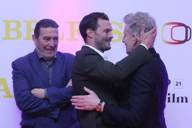 Jamie Dornan greets Patrick Kielty with Ciaran Hinds looking on