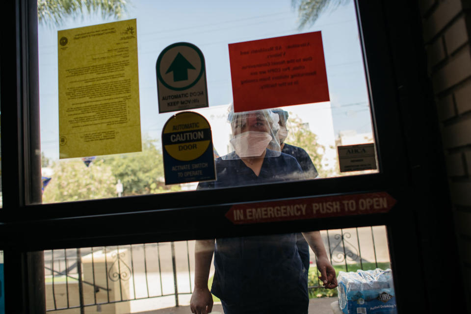 Staff members wait to be let in during shift change at Alexandria Care Center in Los Angeles. | Isadora Kosofsky for TIME