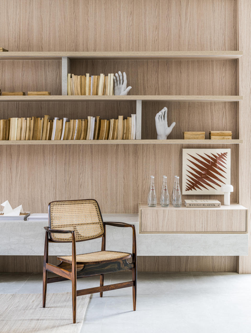 A living room with a built in shelf for books