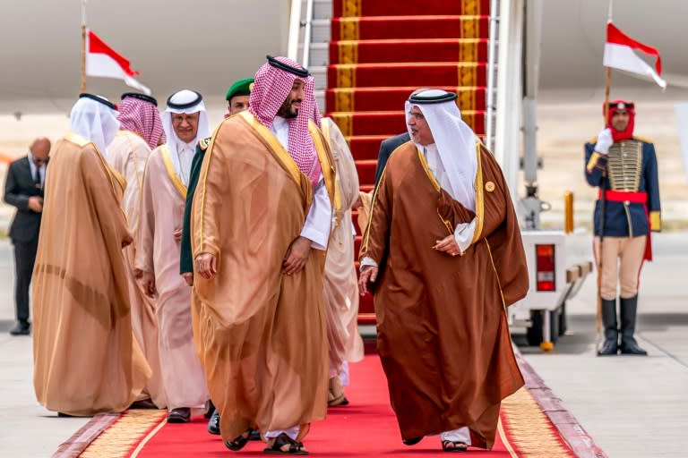 Bahrain's Crown Prince and Prime Minister Salman bin Hamad al-Khalifa greets Saudi Crown Prince Mohammed bin Salman (-)