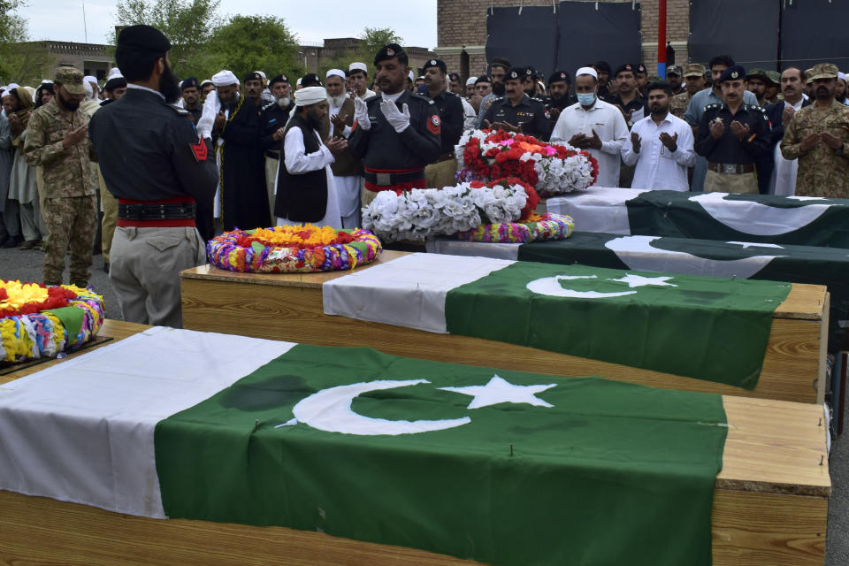 Security officials and others attend funeral prayer of police officer who was killed in a bomb blast, in Lake Mart, a Pakistani town of Khyber Pakhtunkhwa province bordering Afghanistan, Thursday, March 30, 2023. Taliban militants in a pair of attacks killed four police officers by targeting a police vehicle with a roadside bomb and wounded six in an attack on a police station in northwest Pakistan early Thursday, (AP Photo/G.A. Marwat)