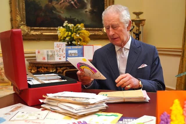 <p>WPA-Rota/Press Association Images</p> King Charles III reads cards and messages, sent by wellwishers following his cancer diagnosis, in the 18th Century Room of the Belgian Suite in Buckingham Palace