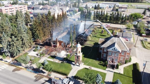 A fire destroyed the century-old Catholic church in Morinville, Alta., about 30 kilometres north of Edmonton, on Wednesday. The fire is being investigated as arson. (David Bajer/CBC - image credit)