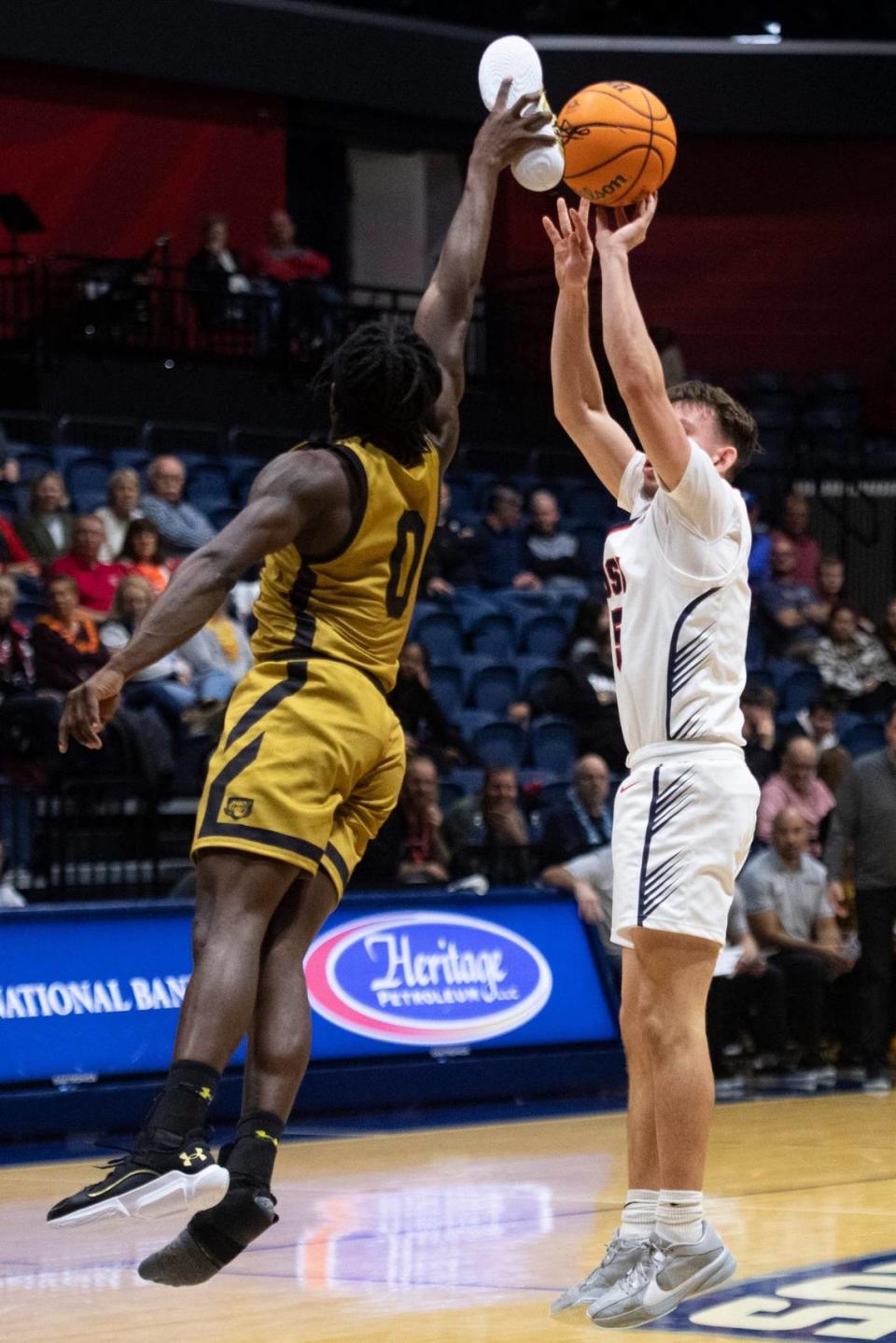 Purdue Fort Wayne’s Rasheed Bello (0) blocks a shot from Southern Indiana’s Jack Campion (5) with his size 12 shoe as the University of Southern Indiana Screaming Eagles play the Purdue Fort Wayne Mastodons at Screaming Eagles Arena in Evansville, Indiana on Wednesday, Dec. 6, 2023.