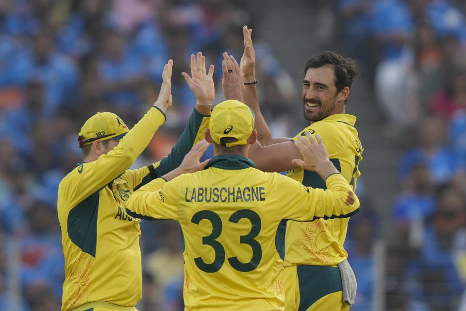 Australia's Mitchell Starc, right, Steve Smith, left, and Marnus Labuschagne celebrates after the dismissal of India's KL Rahul during the ICC Men's Cricket World Cup final match between Australia and India in Ahmedabad, India, Sunday, Nov.19, 2023. (AP Photo/Mahesh Kumar A.)