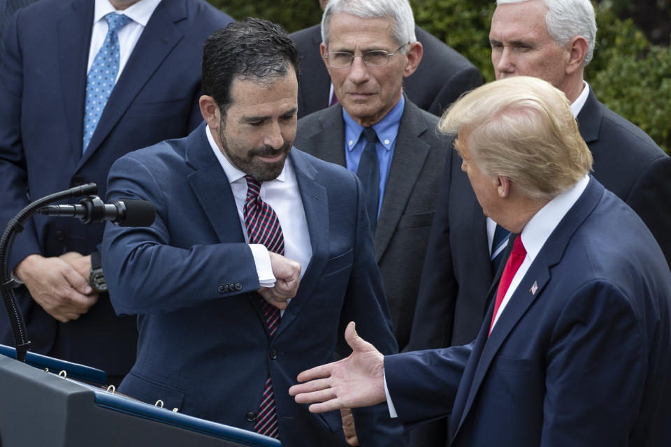 LHC Group's Bruce Greenstein elbow bumps with President Donald Trump during a news conference about the coronavirus in the Rose Garden at the White House, Friday, March 13, 2020, in Washington. (AP Photo/Alex Brandon)