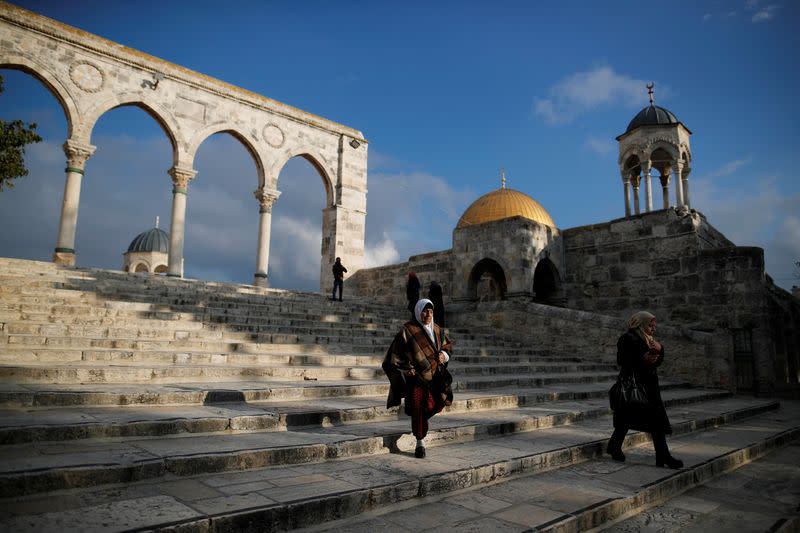 The Dome of the Rock is seen in the background as people visit the compound known to Jews as Temple Mount and to Muslims as Noble Sanctuary, in Jerusalem's Old City