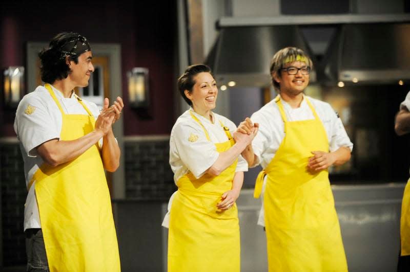 Carrie Mashaney, middle, and two other members of her team, Carlos Gaytan, left, and Brian Huskey, learn their team served the judges’ favorite food on “Top Chef.” Mashaney, an Iowa native, went on to win the challenge.