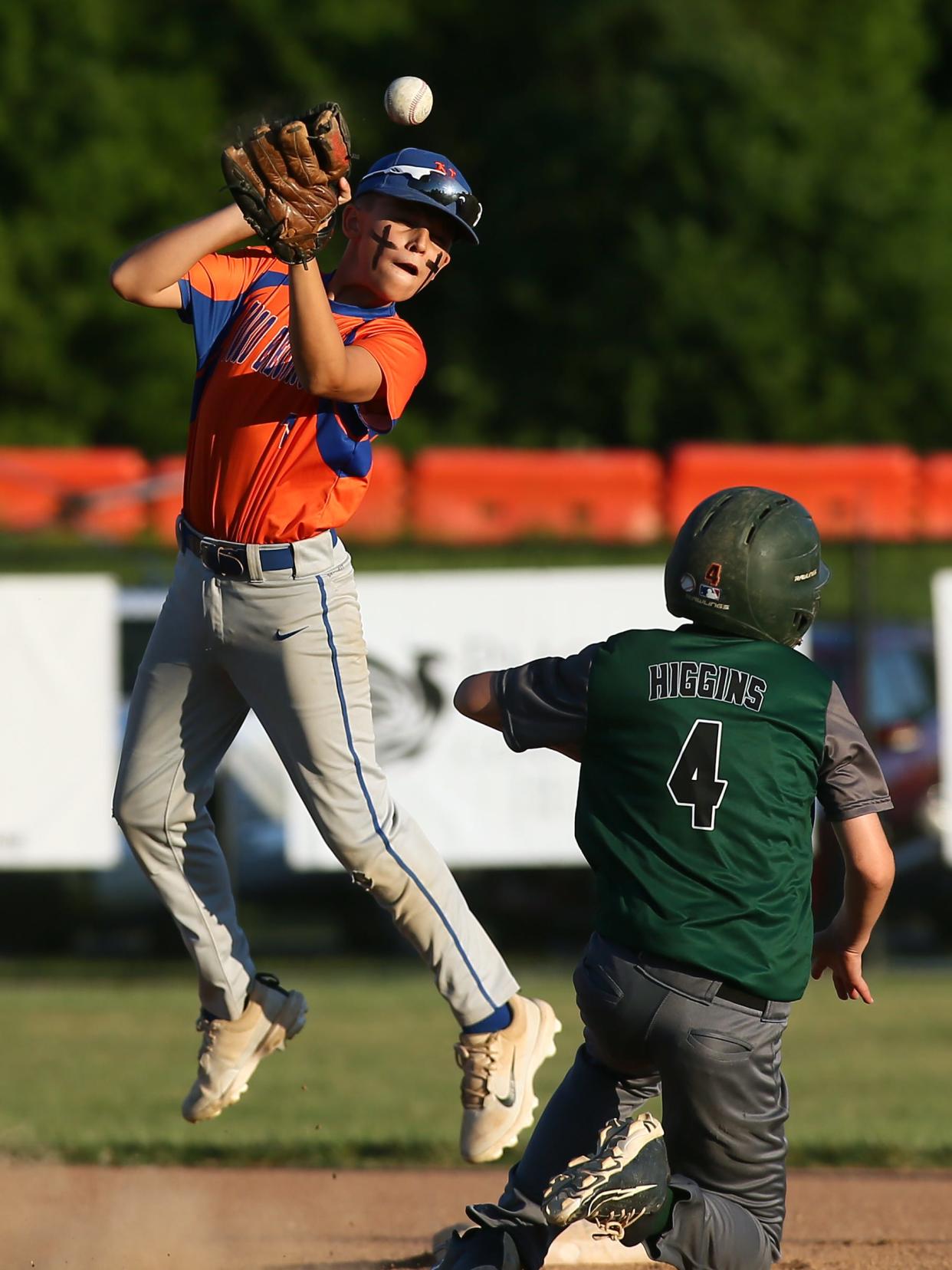 Northridge's Hands and Feet Movement's Finn Higgins slides safely into second as Heath's Ford Electric's Braxton Morgan attempts to handle a throw during the team's 9-1 victory in the Licking County Shrine Tournament Varsity Division final at Mound City on Thursday, June 27, 2024.