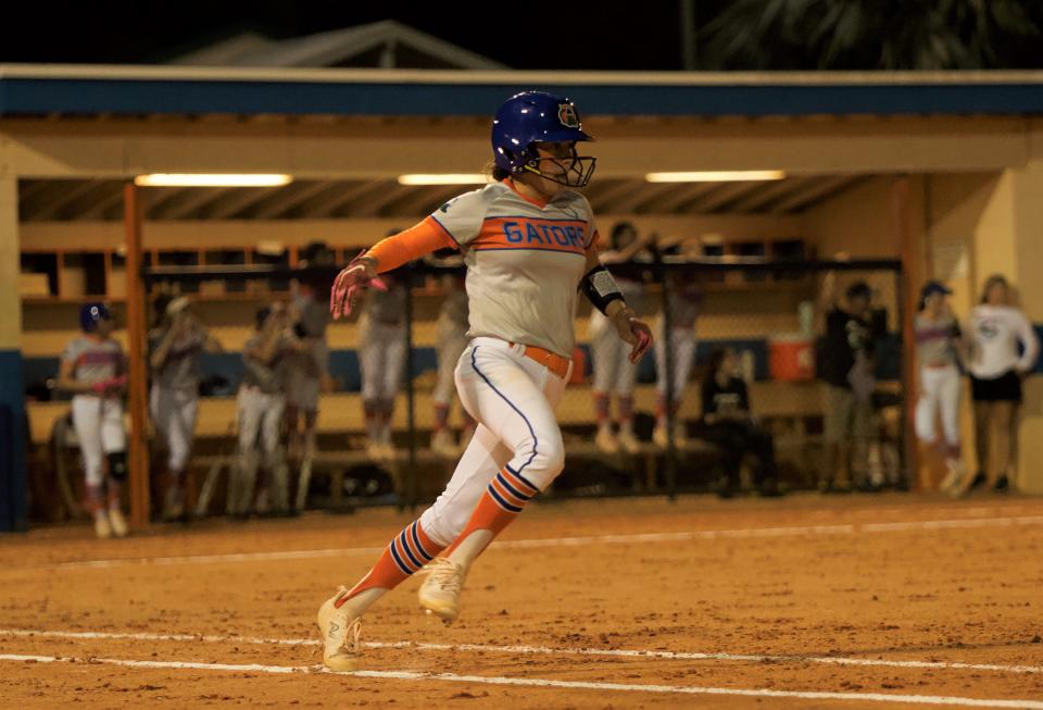 Palm Beach Gardens' Reagan Towns runs to first following her hit in the sixth inning of a game against Seminole Ridge on Mar. 27, 2024.