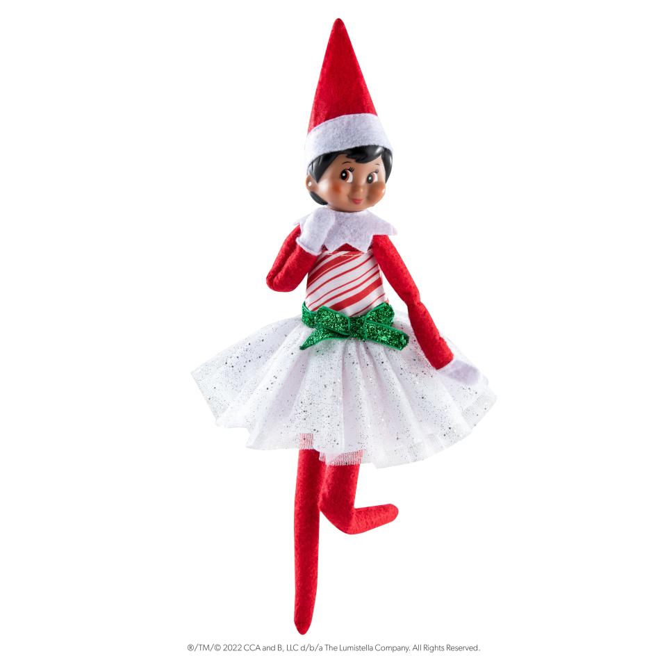 A Scout Elf in a candy cane dress.