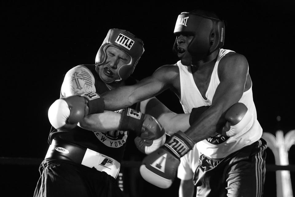 Nick Albergo, left, take one on the chin from Paul Maurice during a grudge match at the “Brooklyn Smoker” boxing event in the parking lot of Gargiulo’s Italian Restaurant in Coney Island, Brooklyn, on Aug. 24, 2017. Maurice won the three-round bout. (Photo: Gordon Donovan/Yahoo News)