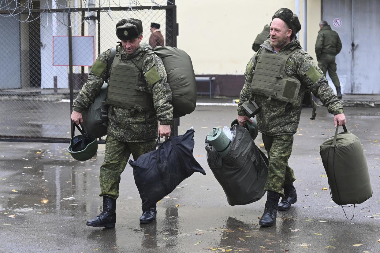 FILE - Recruits carry their new gear at a military recruitment center in Rostov-on-Don, Russia, Monday, Oct. 31, 2022. A campaign to replenish Russian troops in Ukraine with more soldiers appears to be underway again, with makeshift recruitment centers popping up in cities and towns, and state institutions posting ads promising cash bonuses and benefits to entice men to sign contracts enabling them to be sent into the battlefield. (AP Photo, File)